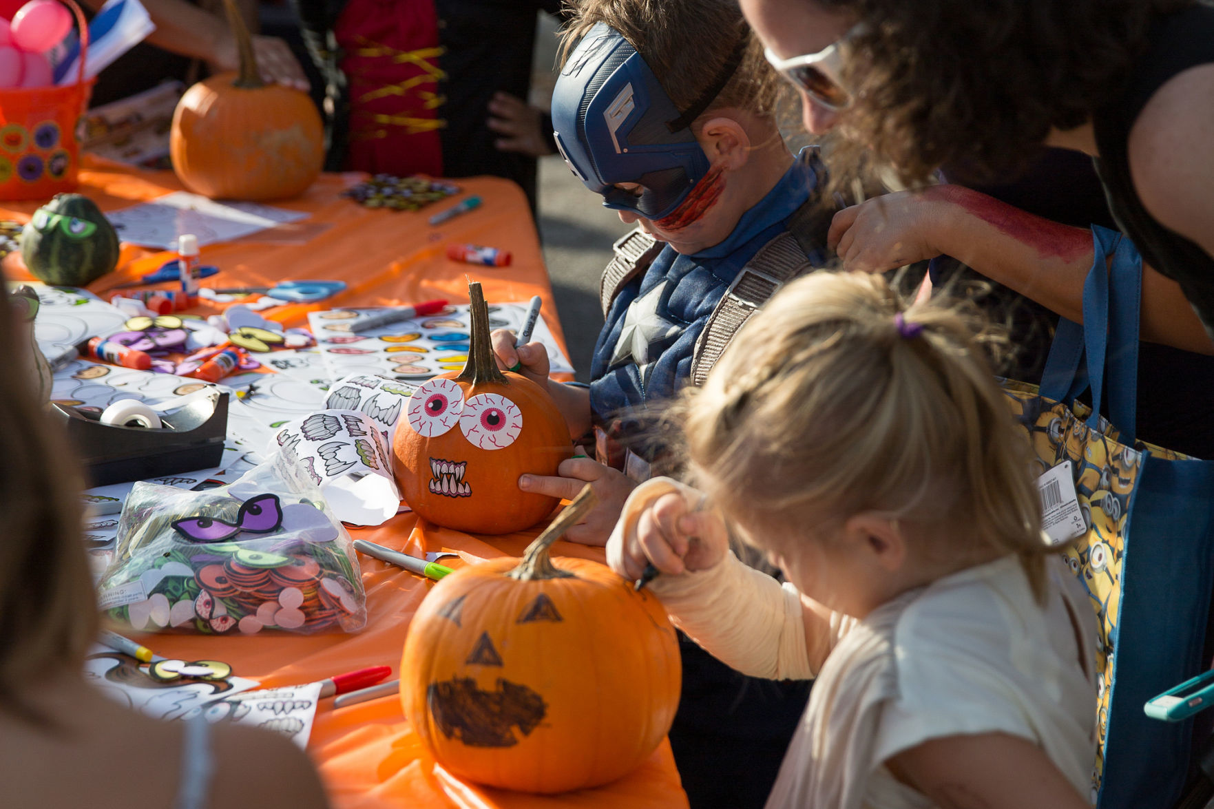 Kids decorating pumpkins